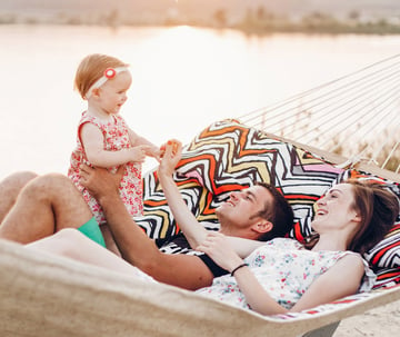 Family playing with a baby on a hammock
